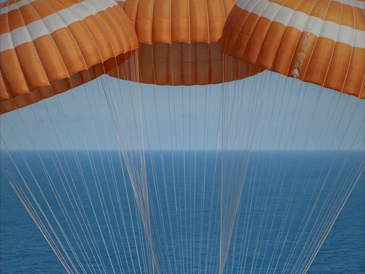 Three parachutes over the ocean, frame from the Artemis 2 film